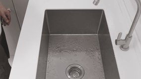 Senior man is washing hand in Kitchen. - Powered by Shutterstock - Get 15% off with code: PIKWIZARD15