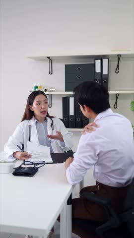 Asian female doctor offers detailed health consultation and creates a personalized treatment plan for patient during professional session in modern clinical office.