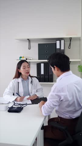 Asian female doctor offers detailed health consultation and creates a personalized treatment plan for patient during professional session in modern clinical office.