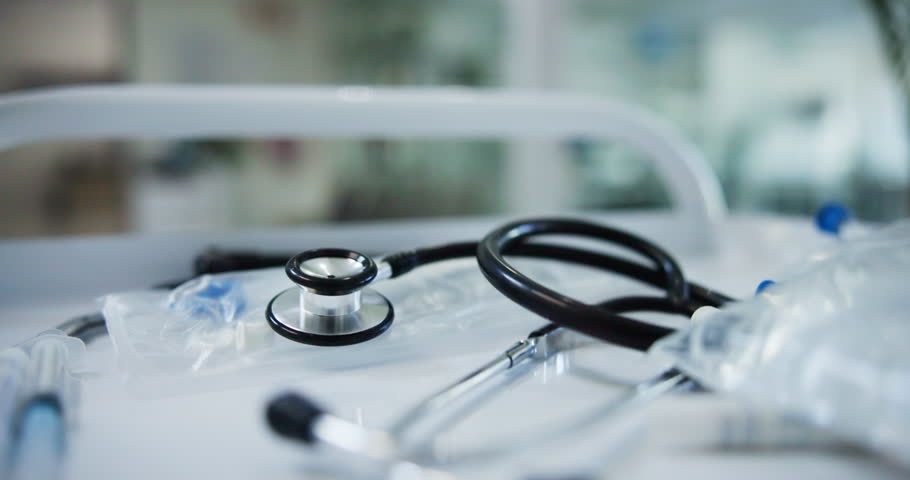 Cardiology, healthcare and urgency with stethoscope in hospital for insurance or wellness closeup. Emergency, instrument and treatment with medical equipment on moving cart for examination in clinic