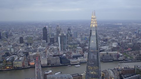 Dramatic aerial shot of the central London skyline featuring The Shard building, River Thames & City of London financial district.