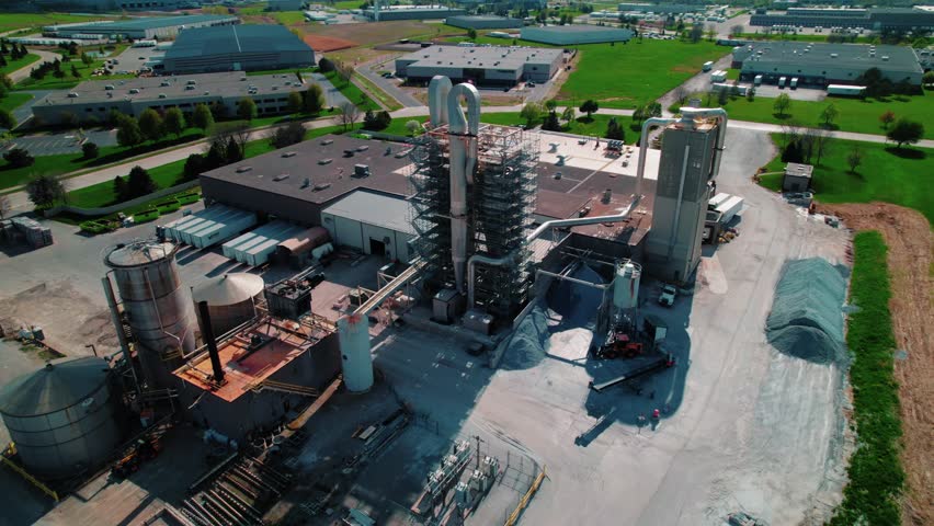 Aerial view of large-scale manufacturing plant with silos and processing towers near De Perre Wisconsin, USA