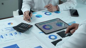 Business colleagues analyzing financial data on a digital tablet - Powered by Shutterstock - Get 15% off with code: PIKWIZARD15