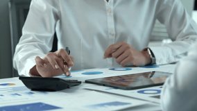 Business team analyzing financial data on digital tablet and calculator - Powered by Shutterstock - Get 15% off with code: PIKWIZARD15