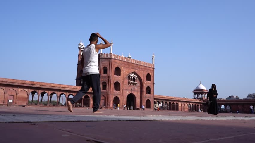 A majestic view of Jama Masjid in Delhi, one of the largest and most iconic mosques in India. The image captures the grand Mughal architecture, with its massive domes, tall minarets.
