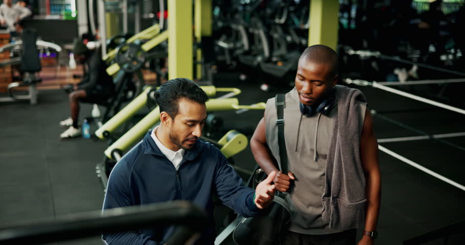 Man, personal trainer and sign up with tablet in gym for planning of training program. Advice, exercise or membership with client and fitness coach in club for development of workout schedule