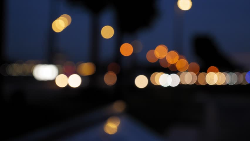Defocused road traffic transport city night. Blurred lights bokeh car headlights driving evening city road. Blurry night city traffic. Out of focus car and truck traffic. Background city street night.