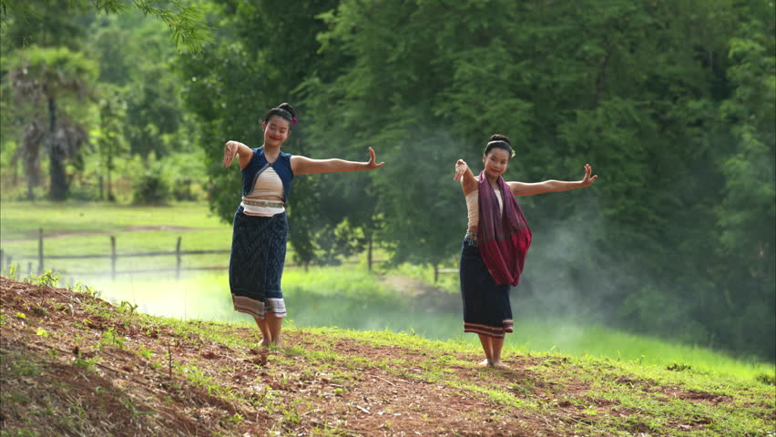 A farmer and a rice worship ritual with a group of traditional dancers