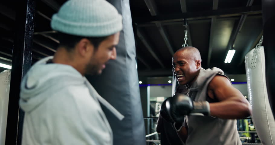 Boxing, exercise or sports with man and personal trainer in gym for motivation or preparation. Fitness, punching bag or training with boxer and coach in health club for development of technique