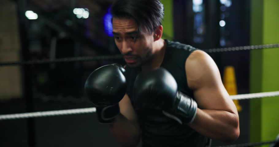 Combat, sports and training with people in boxing gym for fitness, self defense or sparring. Boxer, challenge and fight with men punching in ring for competition, exercise or performance as athlete