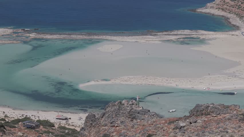 Aerial orbit view of a ship in Balos Beach and Balos Lagoon from Tigani, drone shot 4k, Gramvoussa Peninsula, Crete, Greek Islands, Greece, Europe - D-Log M profile, 3x telephoto lens