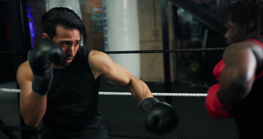 Fight, sports and training with people in boxing gym for fitness, self defense or sparring. Boxer, challenge and combat with men punching in ring for competition, exercise or performance as athlete