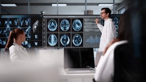 Radiologist Doctor Presents MRI Imaging To Group On Television - Powered by Shutterstock - Get 15% off with code: PIKWIZARD15