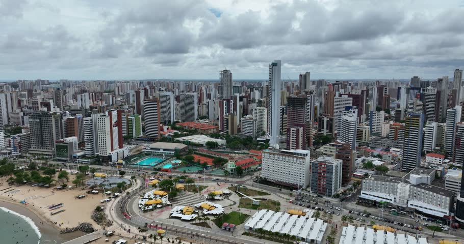 Aerial: Fortaleza cityscape with high rises and skyscrapers during the day in the state capital of Ceara, located in Northeastern Brazil, orbit drone shot