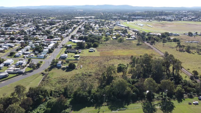 4K aerial view of a suburb with large backyards in Ipswich a small regional town in Australia
