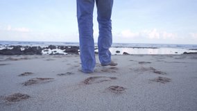 Cinematic gimbal shot of a man walking on a rocky beach during sunset, captured from behind. Soft pastel skies, calm waves, and solitude make this perfect for emotional or travel storytelling. - Powered by Shutterstock - Get 15% off with code: PIKWIZARD15