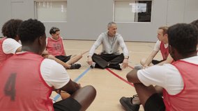 Basketball coach briefing team on court - Powered by Shutterstock - Get 15% off with code: PIKWIZARD15