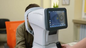 Optometrist examining patient's eye with autorefractor in ophthalmology clinic - Powered by Shutterstock - Get 15% off with code: PIKWIZARD15