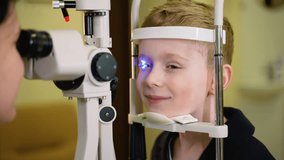 Young boy undergoing slit lamp eye exam - Powered by Shutterstock - Get 15% off with code: PIKWIZARD15