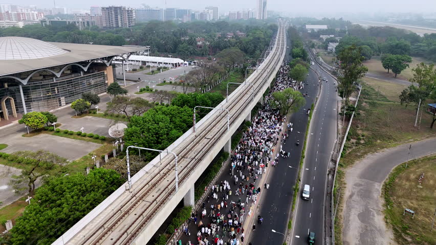 Aerial cinematic drone shot of muslims walking from a mosque after prayer in Bangladesh.