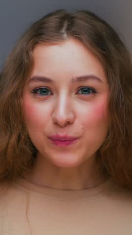 Portrait of Young Woman Eating Food and Looking at Camera. Real Person Consuming Instant Cup Noodles as Quick Dinner Meal. Female Human Inside Cozy Work Office Alone with Lunch and Japanese Chopsticks