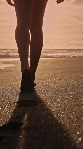 Beautiful Woman Walking on Sandy Beach and Wet Legs Stepping Close-up. Alone Adult Girl at Bright Scenic Sea Going Swim or Splash. Modern Romance of Ocean Bathing and Gorgeous Summer Sky at Shoreline