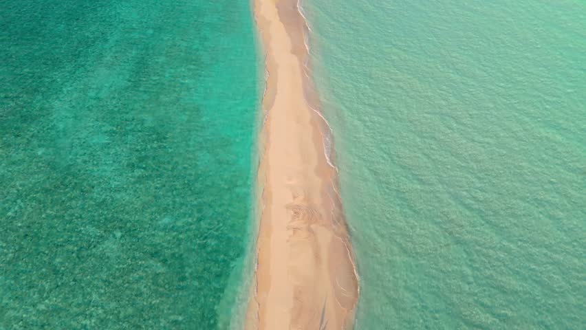 An awe-inspiring aerial drone view captures the Rasdhoo Sandbanks glowing under the soft, golden light of sunset in the Maldives.