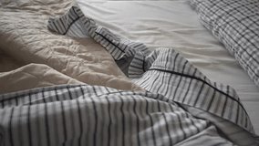 4k slow motion 120 fps Cinematic close-up rotating camera movement over unmade bed sheets and pillows, rising to aerial top view. Morning bedroom scene with natural lighting, intimate atmosphere - Powered by Shutterstock - Get 15% off with code: PIKWIZARD15