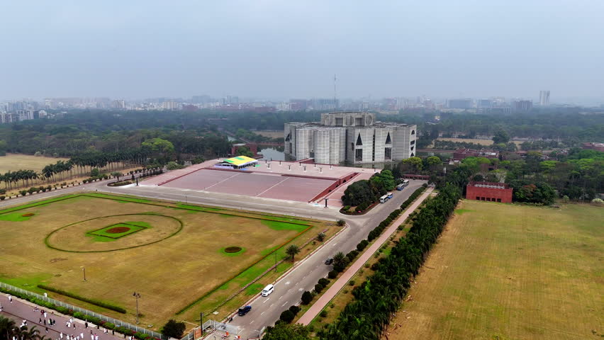 Cinematic pan aerial drone shot of the Jatiya Sangsad Bhaban parliament building and it