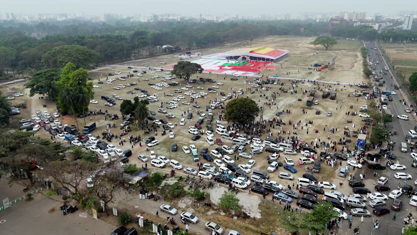 Cinematic aerial drone shot of many people leaving a red building in Dhaka, Bangladesh