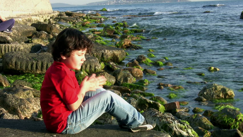 Little boy playing at the seaside