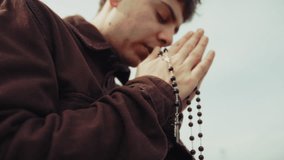 Hands Of A Religious Man Praying With A Rosary And Crucifix - Powered by Shutterstock - Get 15% off with code: PIKWIZARD15