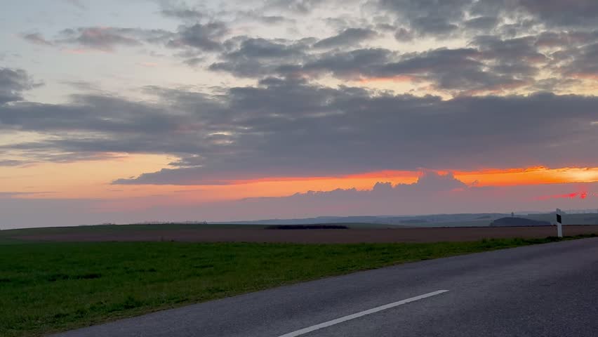 Sunset in the Luxembourg countryside and a secondary road on a spring evening