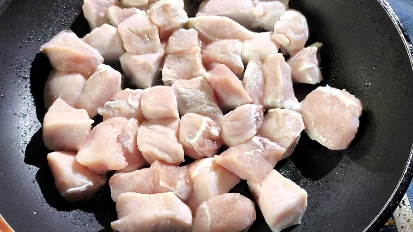Frying chopped pork in pan, in door Chiangmai Thailand.