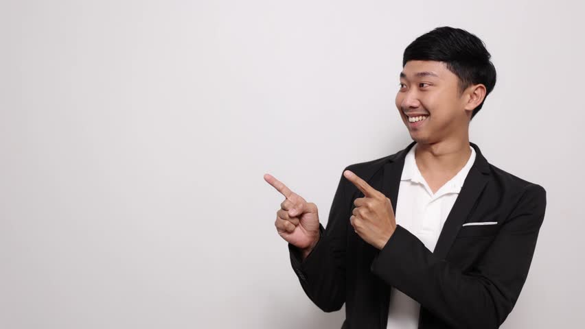 Asian business man happy smile gesture point finger and looking at copy space isolated - Powered by Shutterstock - Get 15% off with code: PIKWIZARD15