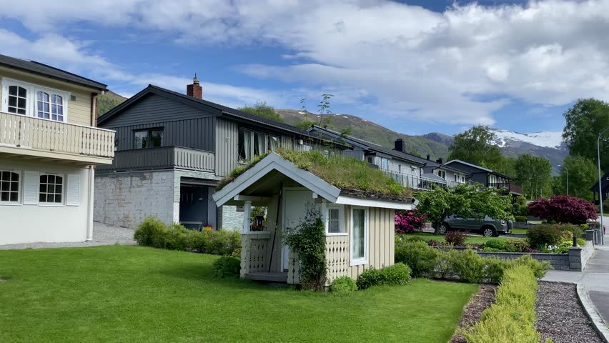 Unique garden shed with green roof in a scenic neighborhood of Norway on a bright sunny day