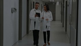 Doctors walking medical corridor while tapping tablet fading profile icon and expanding network map. Healthcare, collaboration, digital, technology, connectivity, professionalism, medical - Powered by Shutterstock - Get 15% off with code: PIKWIZARD15