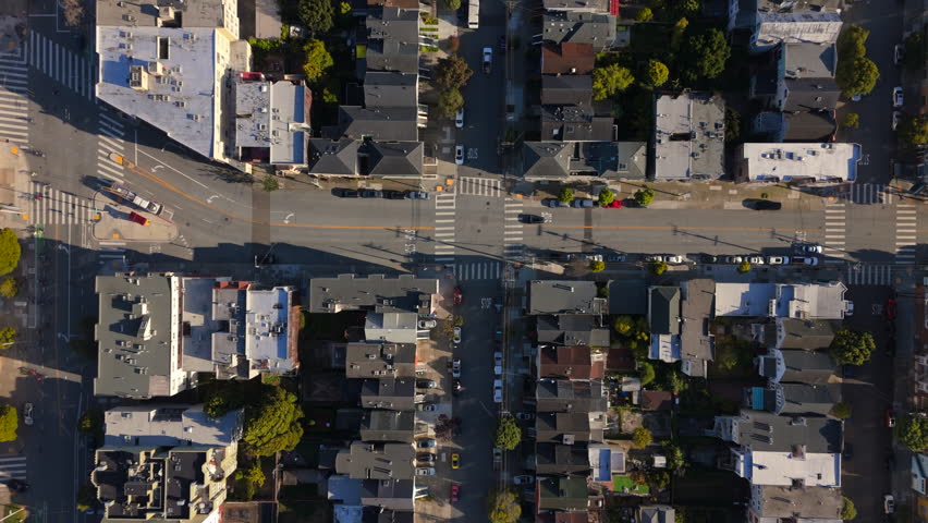 Stunning drone footage highlights a vibrant neighborhood with charming twostory Victorian homes, all nestled in a wellplanned community near the bustling city of San Francisco, California
