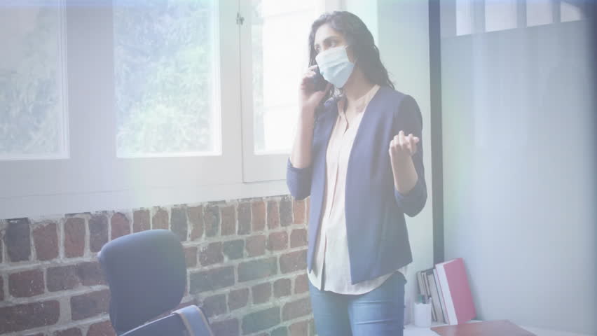 Businesswoman holding smartphone by window, initiating rotating globe while picking up coffee mug. Professional, innovation, communication, modernity, workspace, corporate, technology - Powered by Shutterstock - Get 15% off with code: PIKWIZARD15