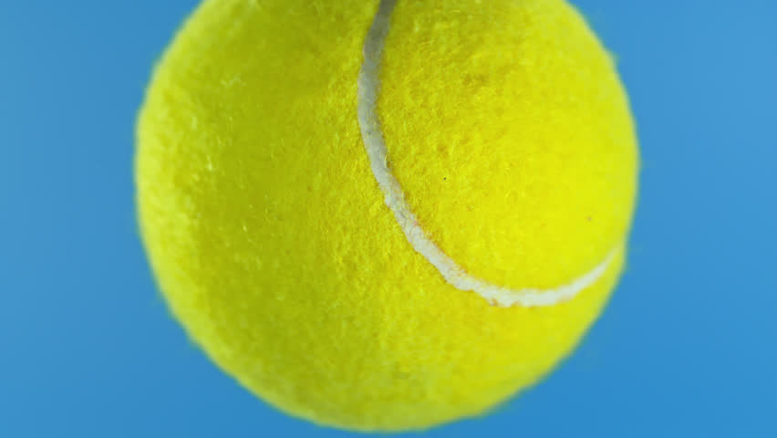 Super Slow Motion of Tennis Ball Hitting Camera on Blue Screen, 1000 fps.