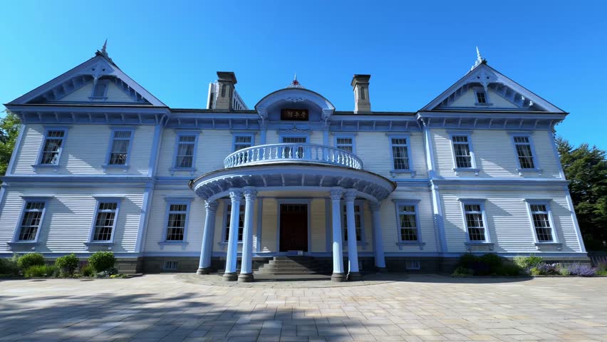 Majestic blue-roofed colonial building in Sapporo Nakajima Park with large pillars