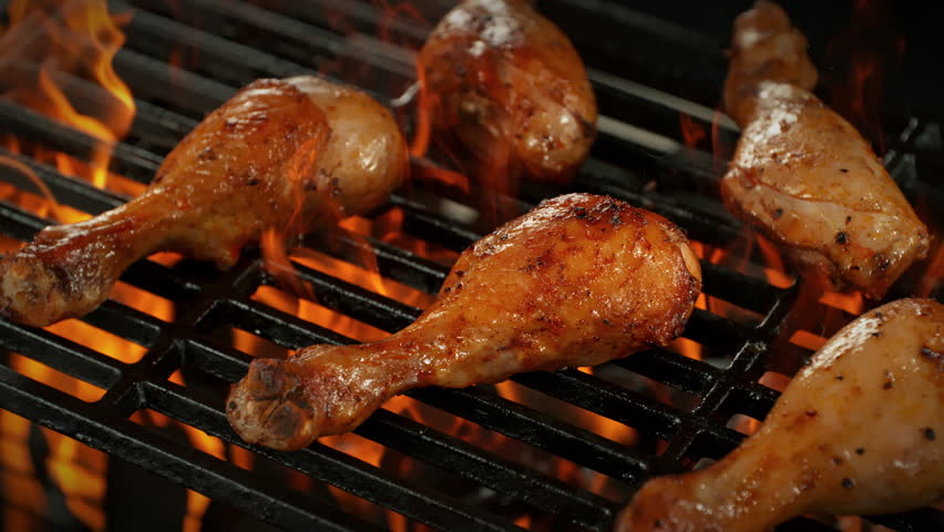 Super Slow Motion Shot of Chicken Drumsticks on Fired Up Grill with Camera Motion at 1000fps.