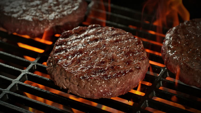 Super Slow Motion Shot of Hamburger Meat on Hot Grill with Camera Motion at 1000fps.