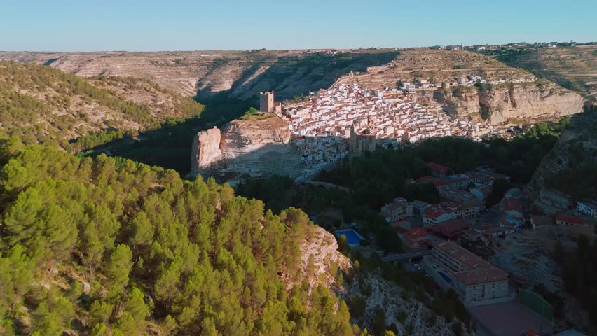 Aerial view of Alcala del Jucar medieval town on the cliff between the bends of the Jucar river in the province of Albacete at sunrise, Castile-La Mancha, Spain