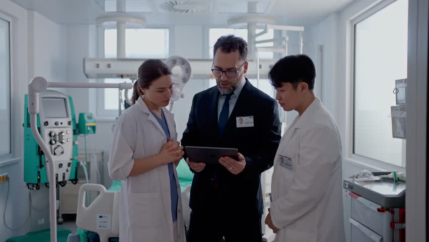 Pharmaceutical sales respresentatives showing doctor new medications. Group presentation in hospital setting.