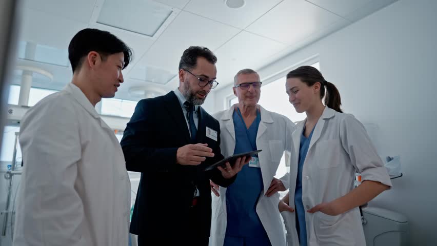 Pharmaceutical sales respresentative showing doctor new medications. Group presentation in hospital setting.