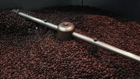 Freshly Roasted Coffee Beans Cooling in Tray with Spinning Arms – 4K Footage High-quality 4K video showing freshly roasted coffee beans being cooled in a circular cooling tray.	 - Powered by Shutterstock - Get 15% off with code: PIKWIZARD15