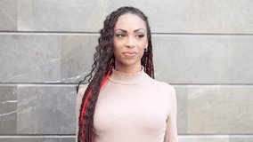 A stylish and confident woman with beautifully braided hair poses elegantly against a textured wall, showcasing her unique and vibrant fashion sense that captures everyones attention - Powered by Shutterstock - Get 15% off with code: PIKWIZARD15