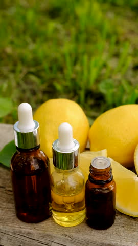 lemon essential oil in a bottle. Selective focus.