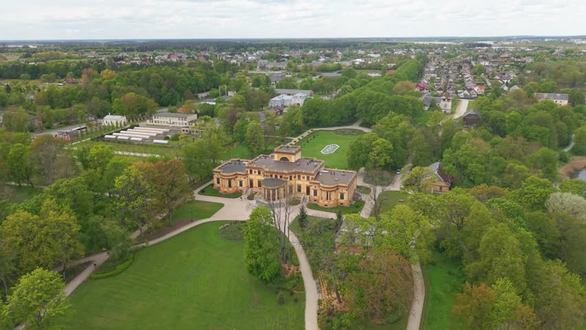 A Drone footage of a Traku Voke Manor heritage museum in Vilnius, Lithuania with green lush landscape